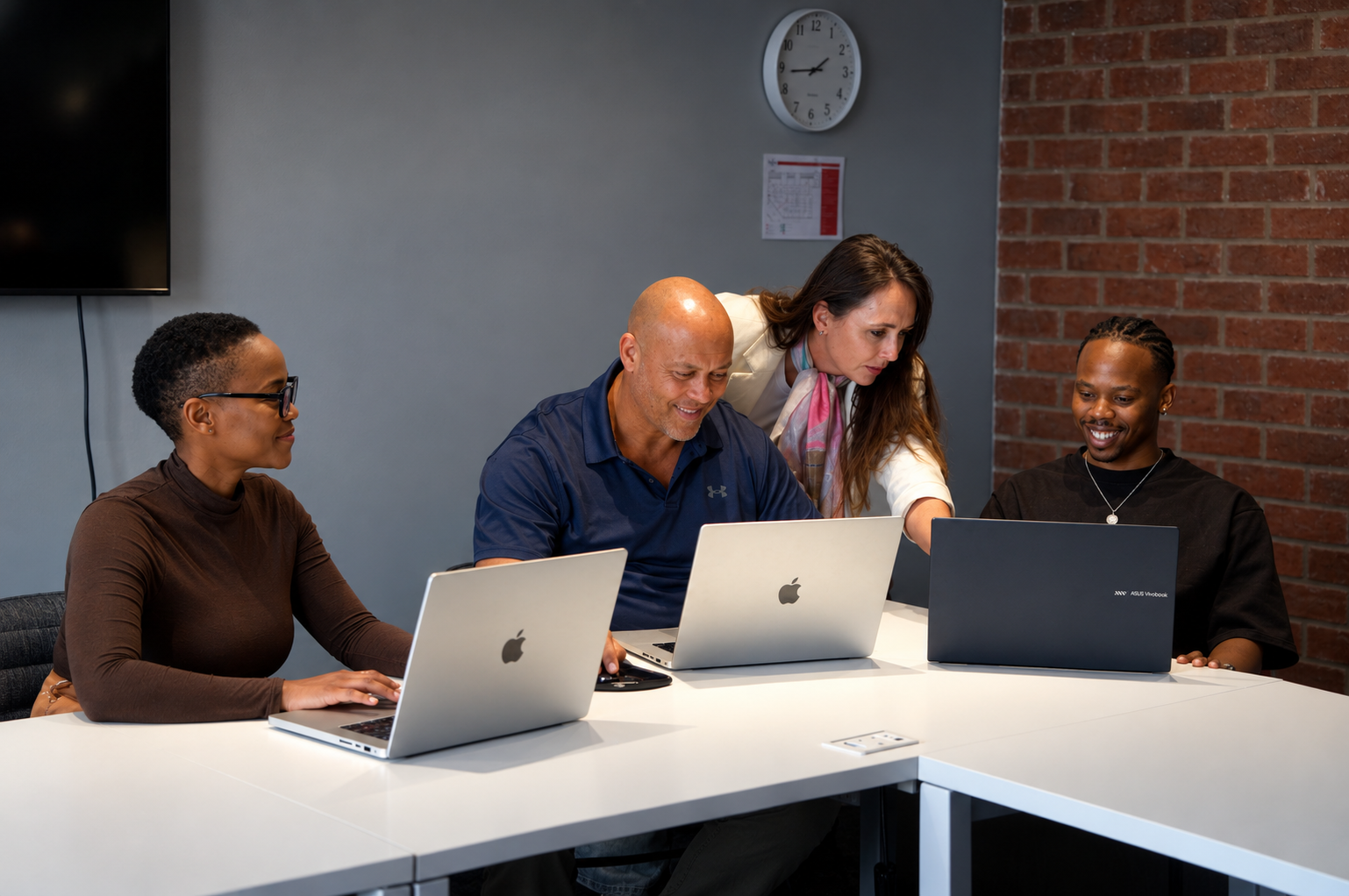 The DeployToday.AI team working together around a table